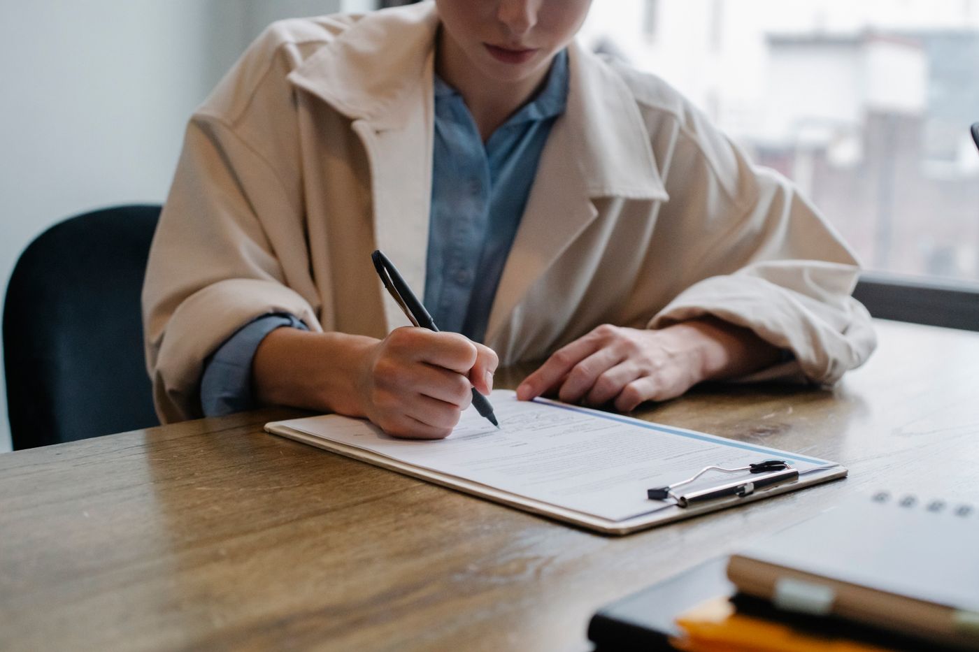 A professional completing information during a recruiter conversation
